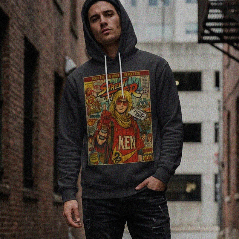 A stylish man wearing a SukiPrime hoodie featuring a retro vintage comic book cover design of Ken from Street Fighter, set against an urban backdrop.