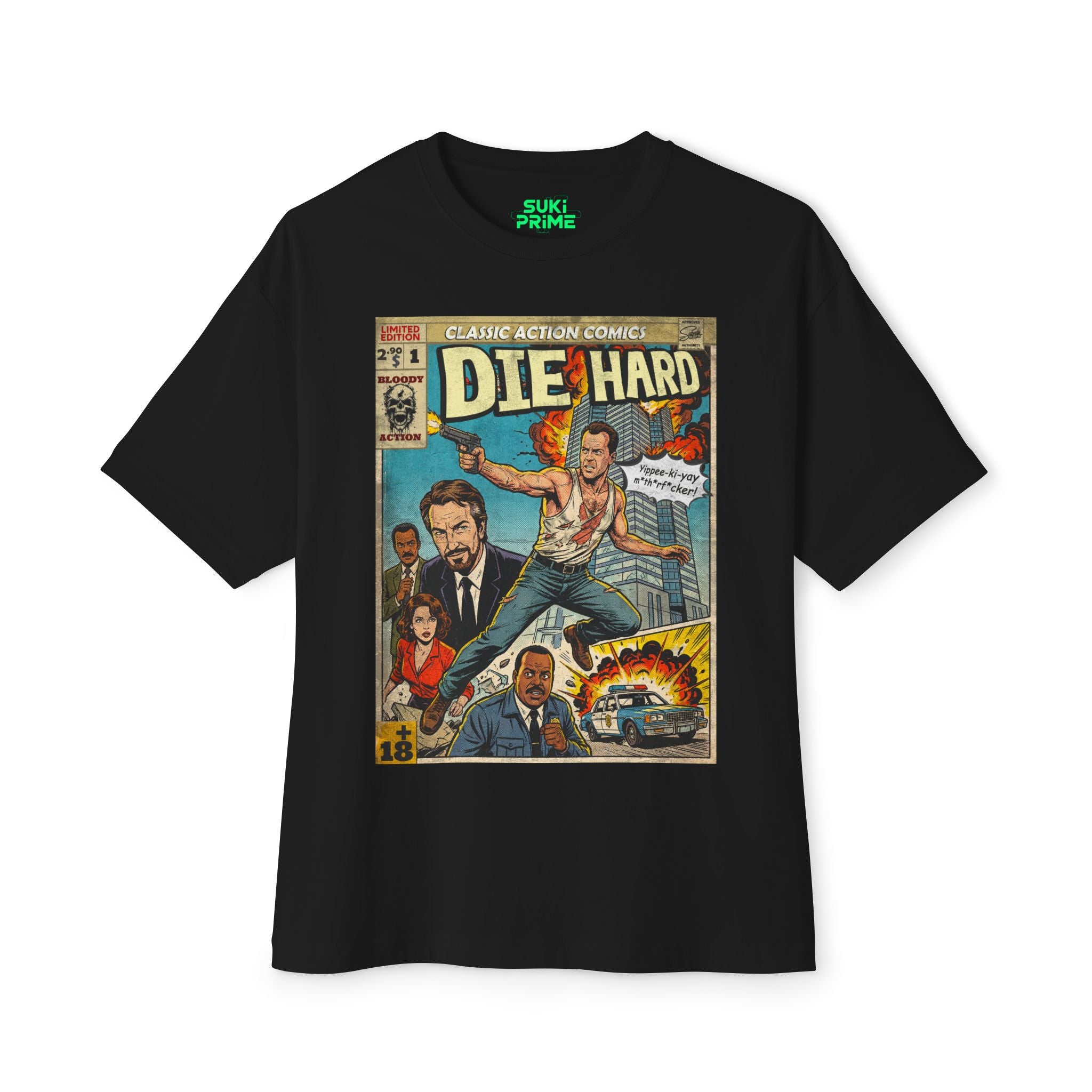 A black oversized t-shirt featuring a vintage comic-style illustration of the movie Die Hard. The graphic shows John McClane in a white tank top jumping through the air while firing a handgun, with a burning Nakatomi Plaza skyscraper in the background. Supporting characters Hans Gruber, Holly Gennaro, and Sergeant Al Powell are also depicted. A speech bubble from McClane reads 'Yippee-ki-yay mthrf*cker!' The inner neckline of the shirt has a 'Suki Prime' logo.