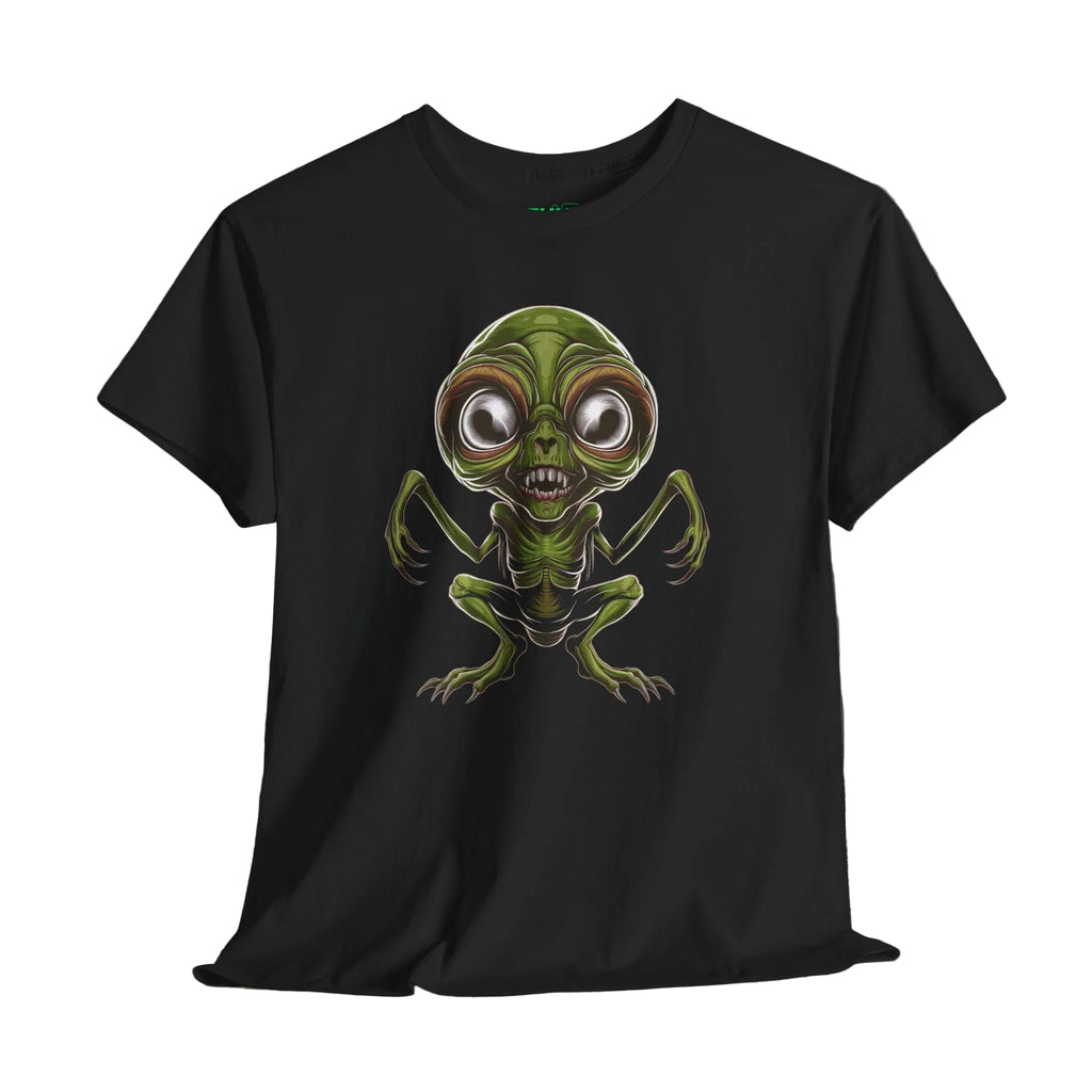 Black t-shirt with a green alien design on a wooden surface and dark background